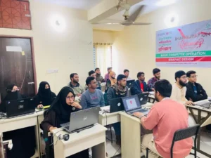 Young women and men working at laptops during the opening session of a basic computer operation and graphic design course