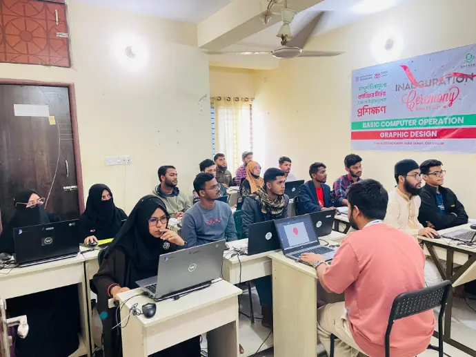 Young women and men working at laptops during the opening session of a basic computer operation and graphic design course