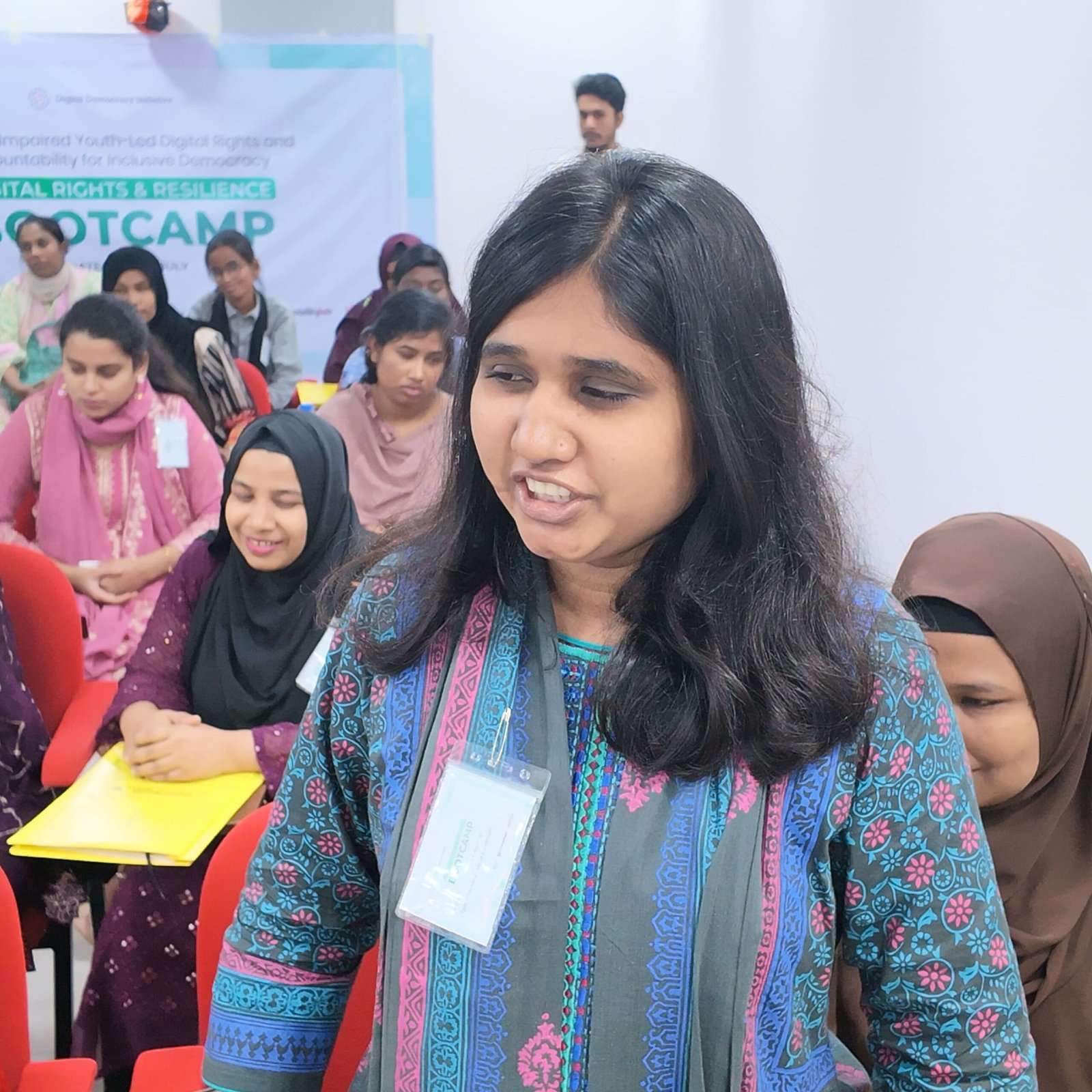 A young woman with a visual impairment speaking and sharing her perspective on digital accessibility during the Bootcamp session