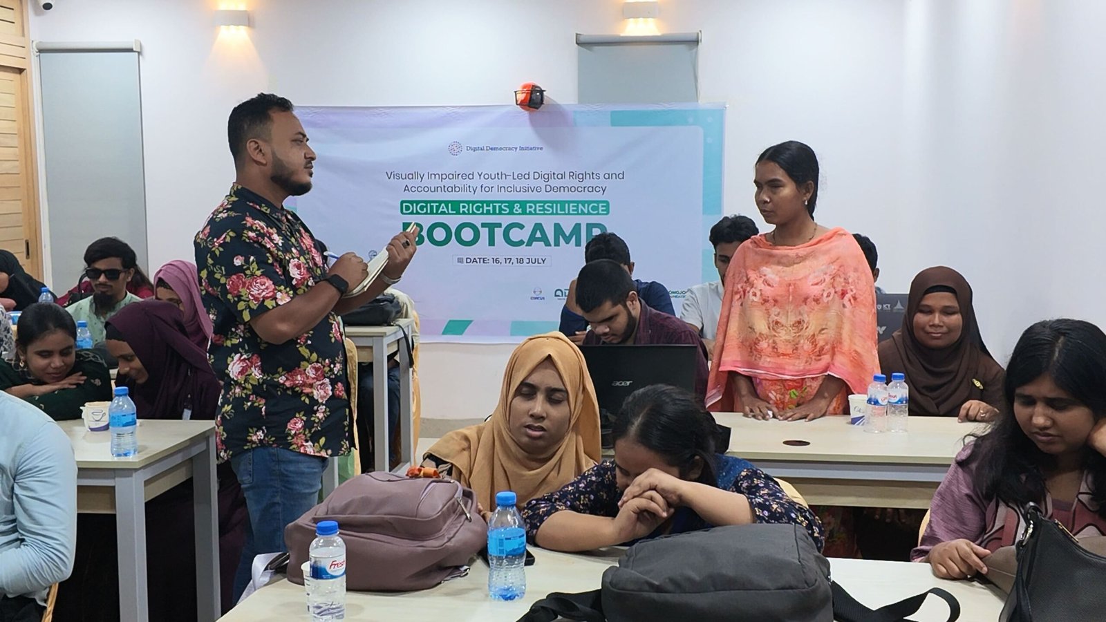 A facilitator leading an interactive discussion with youth participants taking notes during the Digital Rights & Resilience Bootcamp