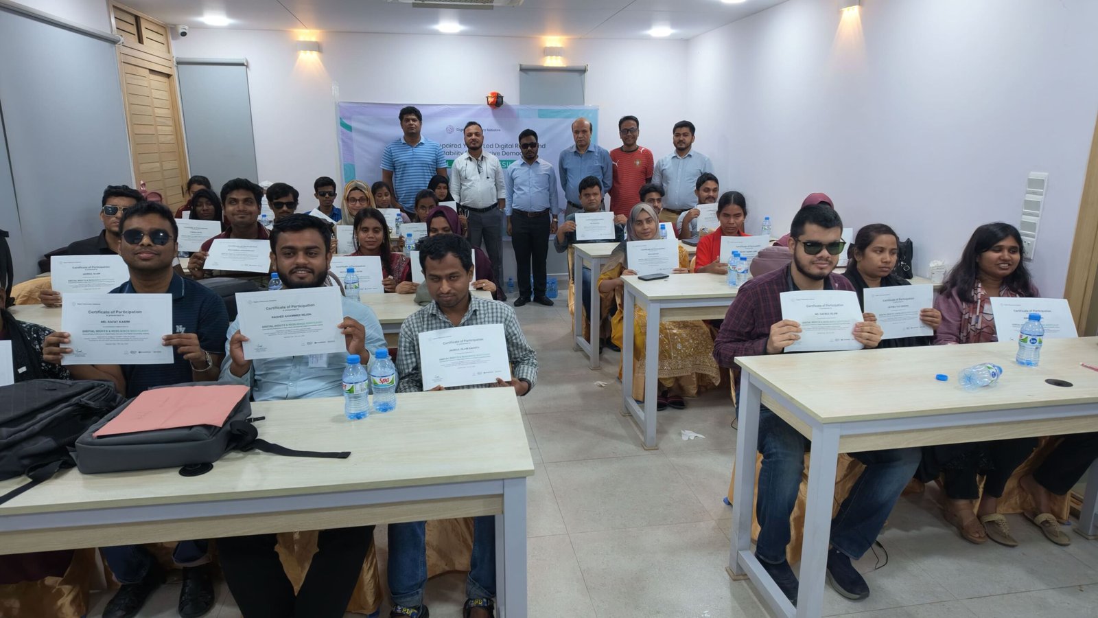 Full group photo of 30 trained youth accessibility auditors with disabilities holding their certificates alongside project organizers at the completion of the Bootcamp