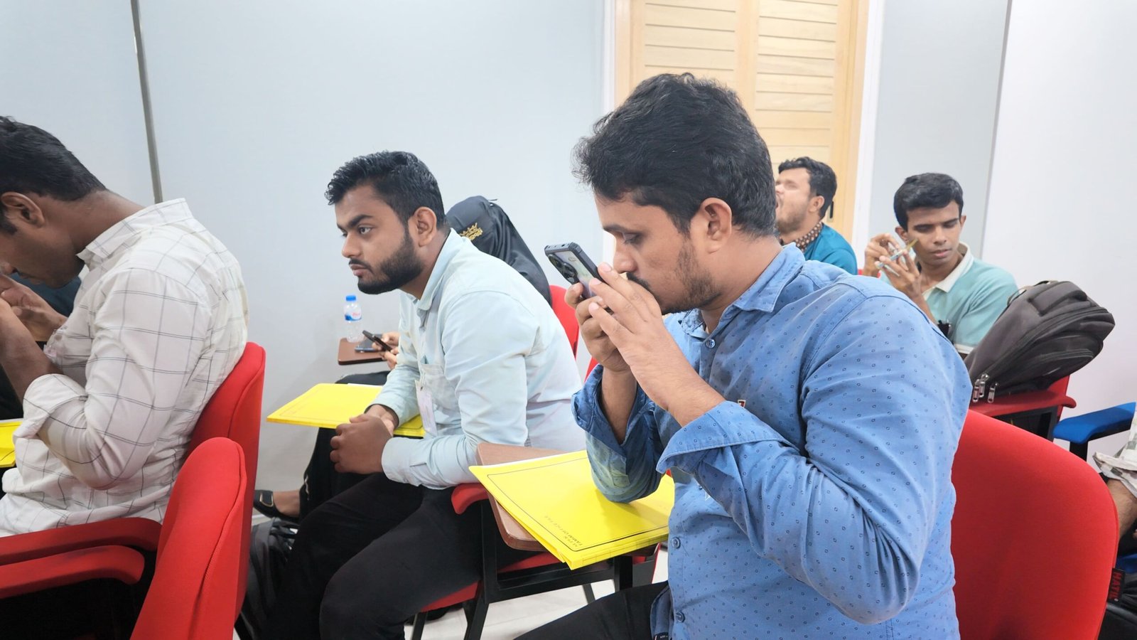 Visually impaired youth participants using mobile accessibility tools and screen readers during a practical session of the Digital Rights & Resilience Bootcamp